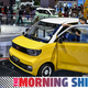 People look at a Wuling Hong Guang Mini EV during the 19th Shanghai International Automobile Industry Exhibition in Shanghai on April 20, 2021. (Photo by Hector RETAMAL / AFP) (Photo by HECTOR RETAMAL/AFP via Getty Images)